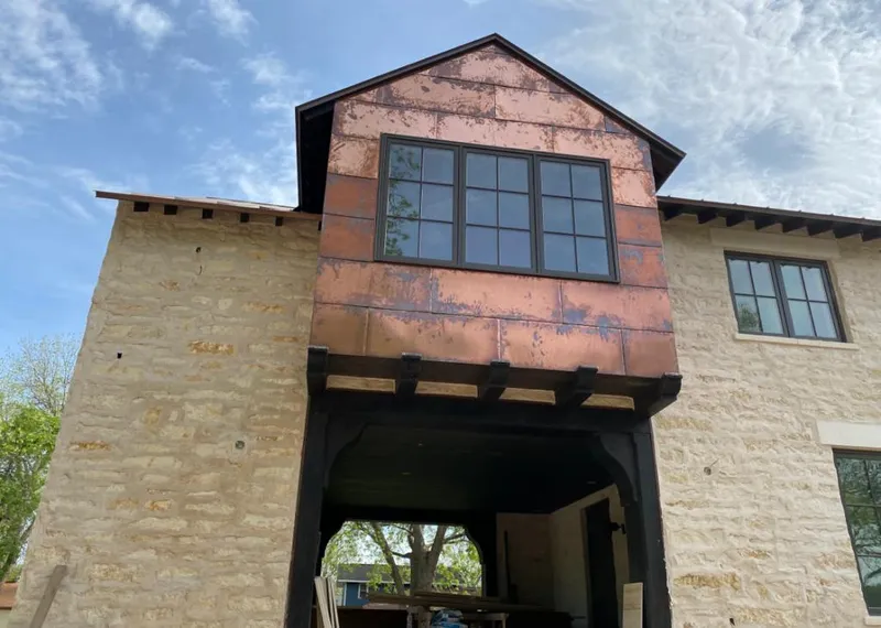 Copper metal panel facade on a stone building for Skylight Installation in Norman